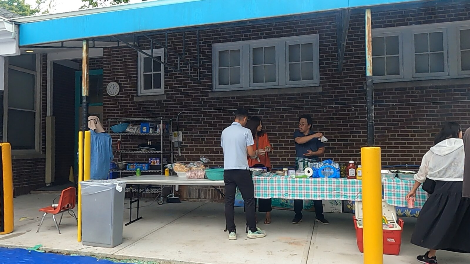 Tables of light refreshments set up in front of the school building